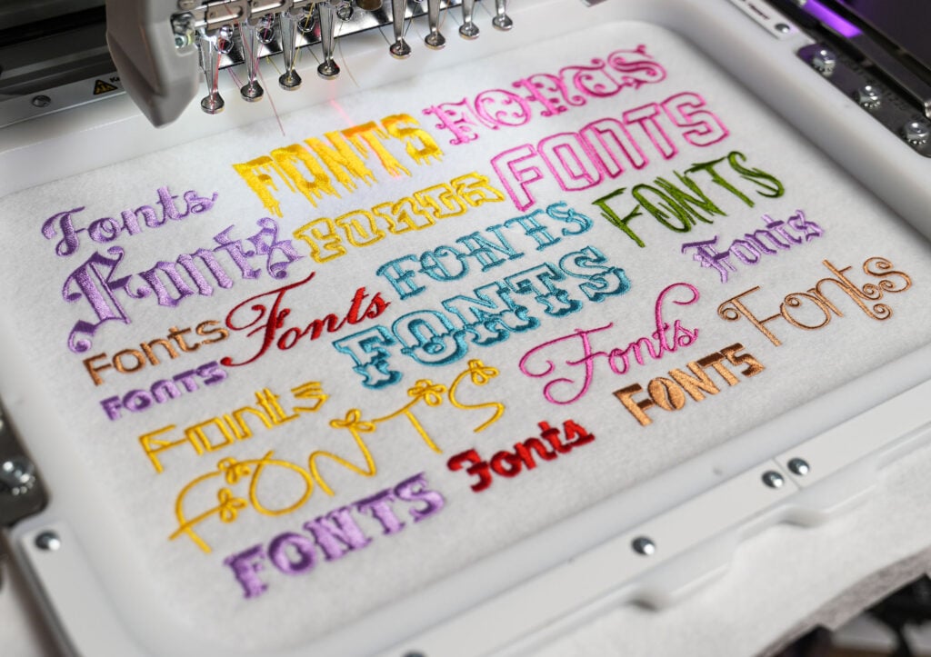 embroidery machine with various colorful embroidery fonts sewn onto fabric