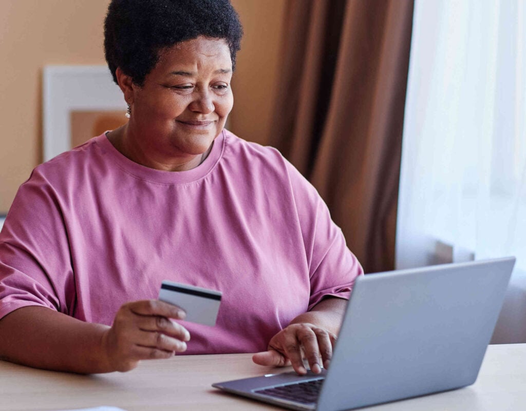 safe-and-secure-online-shopping Older lady smiling making a purchase online